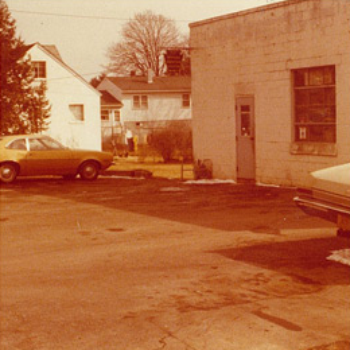 Vintage auto shop exterior with cars
